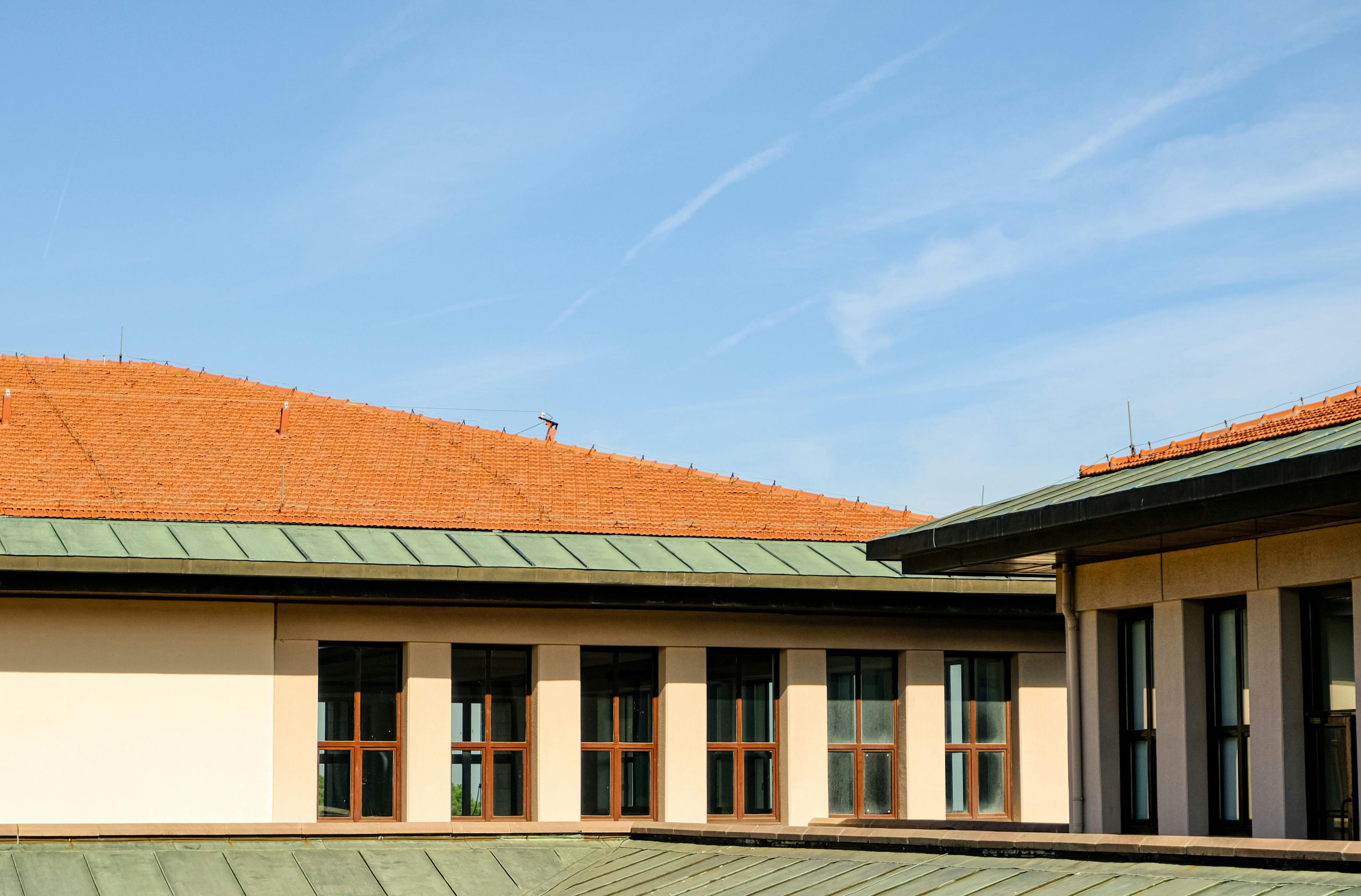 Contemporary architecture featuring clean rooflines against a bright blue sky.